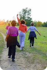 Female Friends over fifty exercising outdoors.