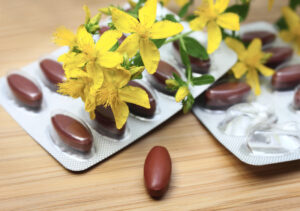 St. John's wort flower tops with medicine tablets in blister pack