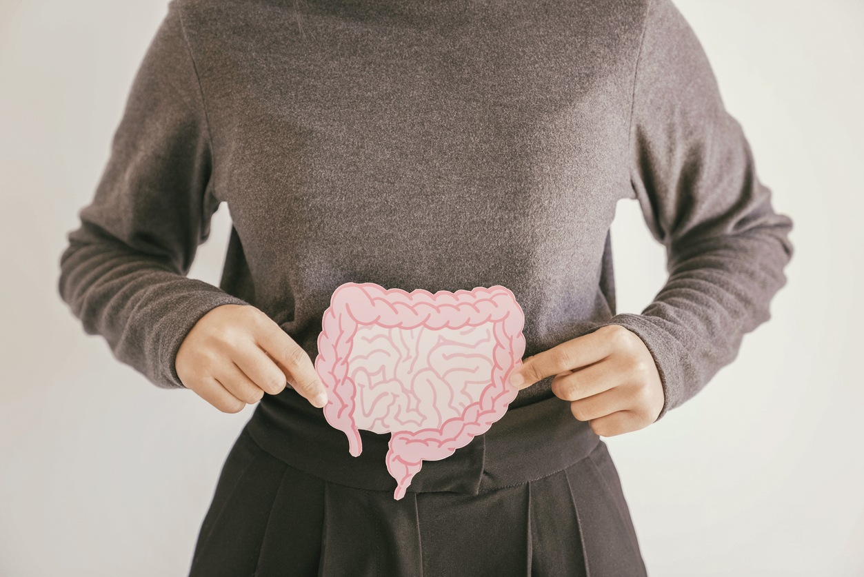 Woman hands holding intestine shape, healthy bowel digestion, leaky gut, probiotic and prebiotic for gut health, colon, gastric, stomach concept